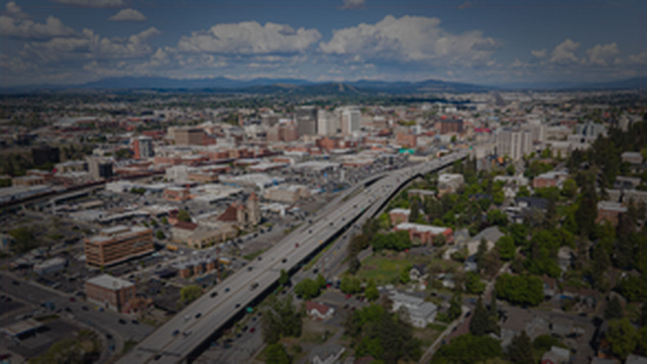 Spokane skyline themed Pine Script service cover with dark market grading